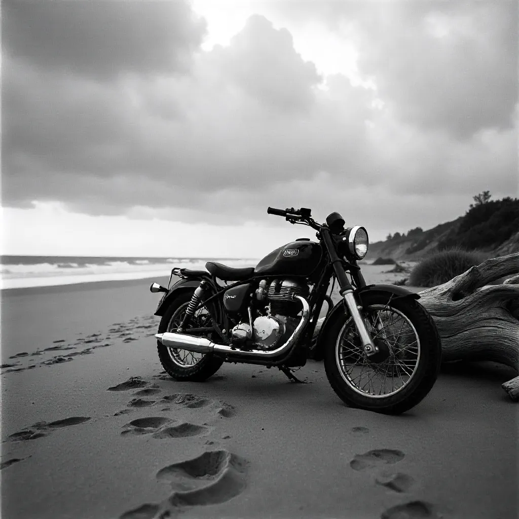 Monochrome Beachside Motorcycle Amid Driftwood and Clouds