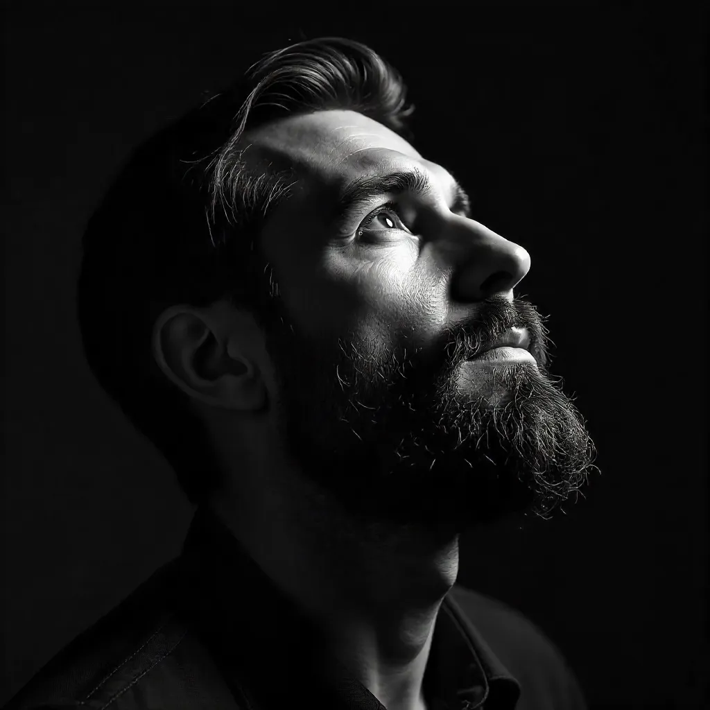 Upward Gaze: Bearded Man in Monochrome